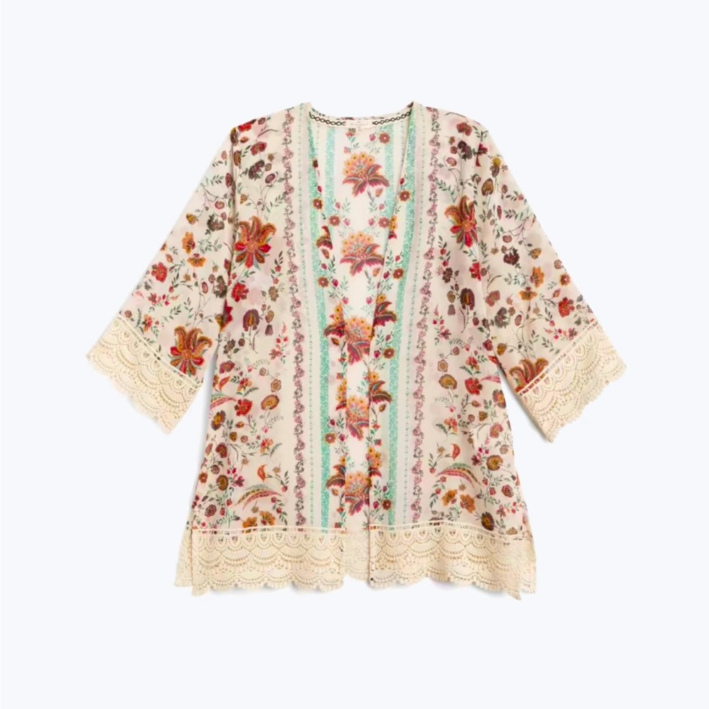 Kimono top in cream color with burgundy floral pattern with crocheted sleeves.